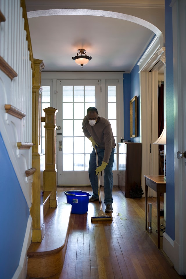 Man mopping the floor