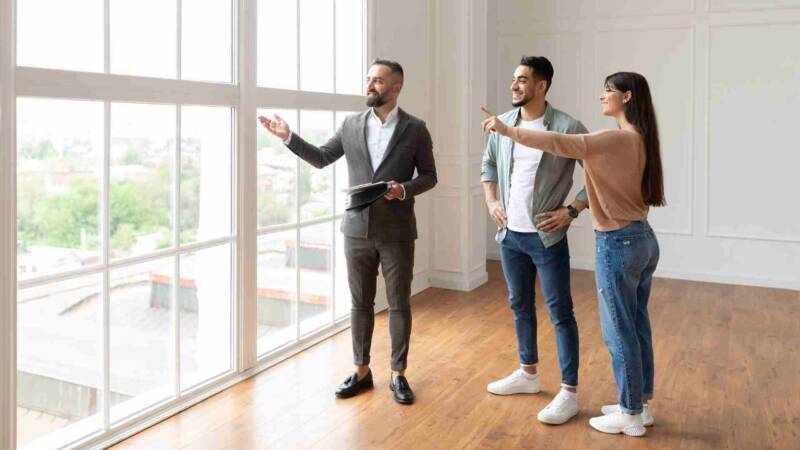 A property management agent presenting the house to a couple