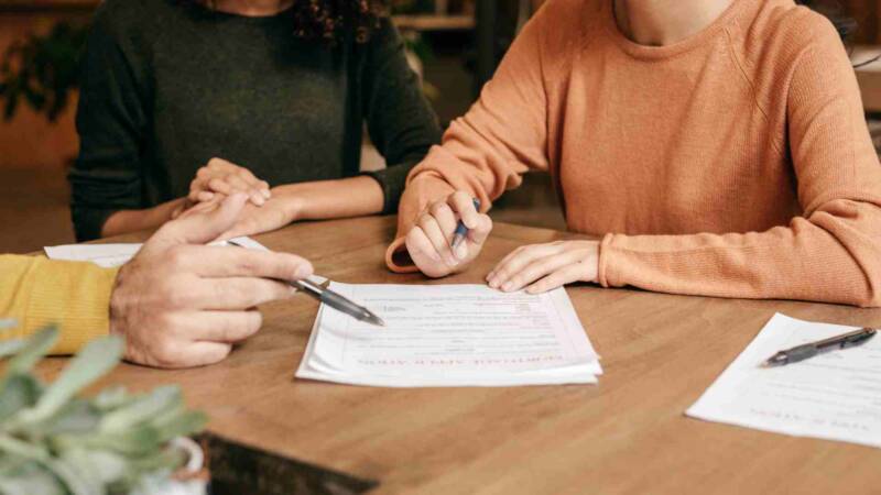 A foreign investor being guided to buy a franchise while reading a contract