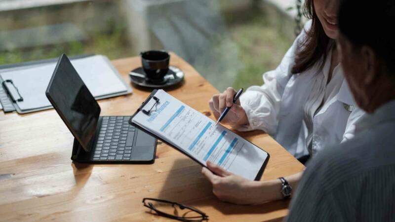 A client reviewing health insurance form