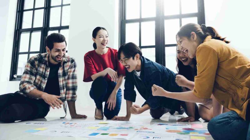 A team of E2 visa investors cheering over their achievements